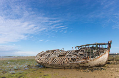Wreck of old wooden boat stranded on a beach in brittany