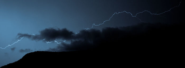 Low angle view of lightning against sky at night