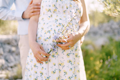 Midsection of woman holding plant