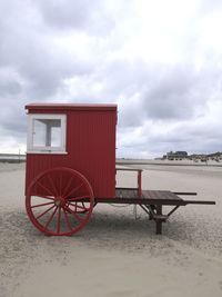 Lifeguard hut on beach against sky