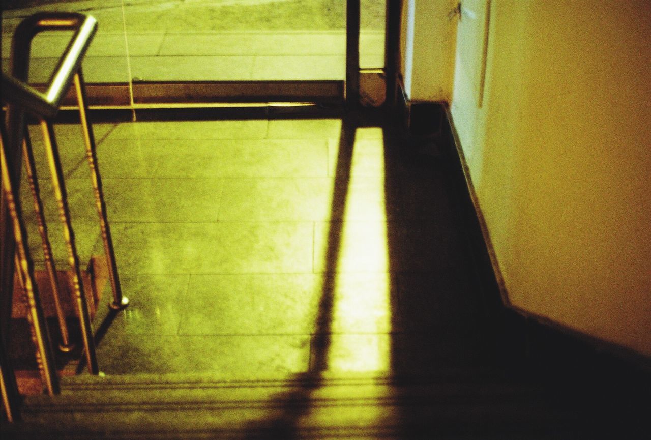 indoors, empty, shadow, flooring, sunlight, absence, steps, tiled floor, high angle view, home interior, window, railing, architecture, staircase, built structure, no people, door, steps and staircases, wall - building feature, chair