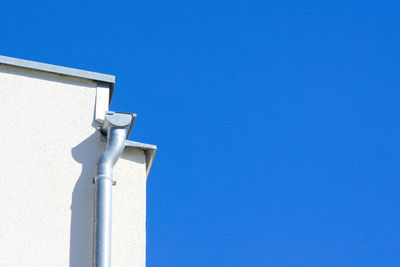 High section of built structure against clear blue sky