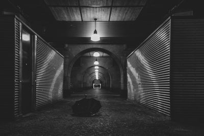 Empty corridor in illuminated building