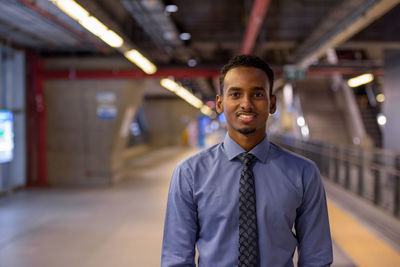 Portrait of young man standing in city