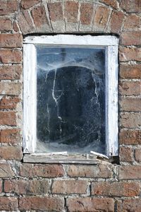 Close-up of window on brick wall