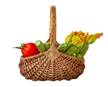 Close-up of fruits in basket against white background