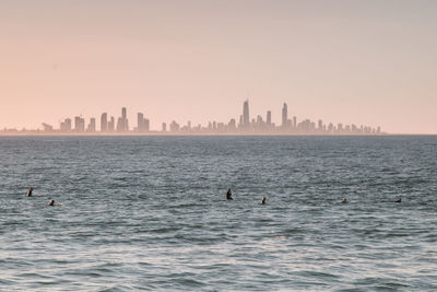 View of city by sea against sky