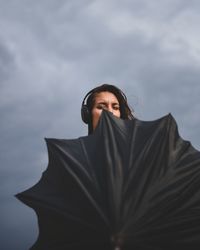 Portrait of woman standing against sky