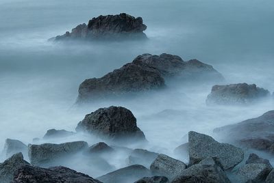 Panoramic view of sea and rocks against sky