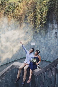 Rear view of couple standing against blurred background