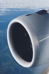 Close-up of airplane engine against sky