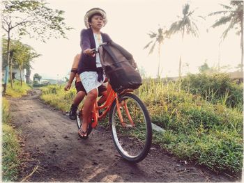 Portrait of young woman riding bicycle