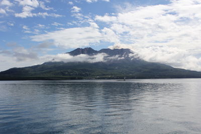 Scenic view of sea and mountains against sky