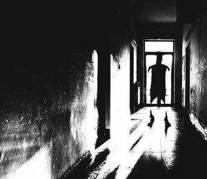 Silhouette woman standing in corridor