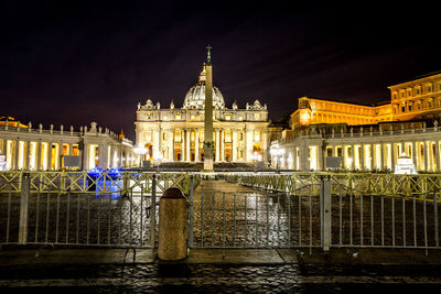 Statue in city at night