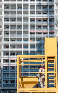 Worker in front of a building under construction