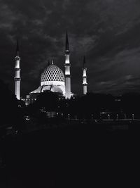 Cathedral in city against sky at night