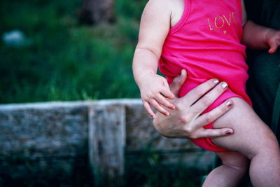 Midsection of mother carrying daughter