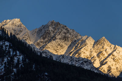 Scenic view of snowcapped mountains against clear sky