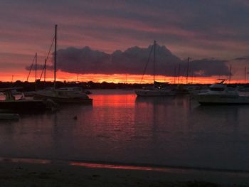 Sailboats in marina at sunset