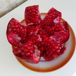 High angle view of chopped cherries against white background