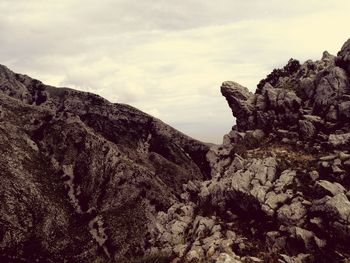 Rock formations on mountain against sky