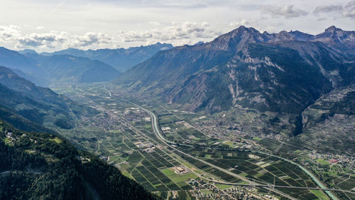 High angle view of land and mountains against sky