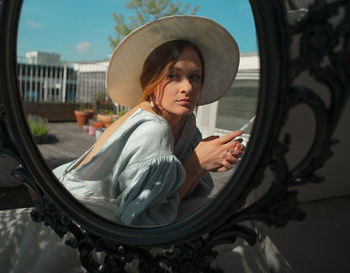 Portrait of young woman wearing hat