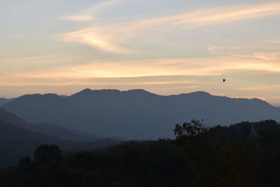 Scenic view of silhouette mountains against sky at sunset