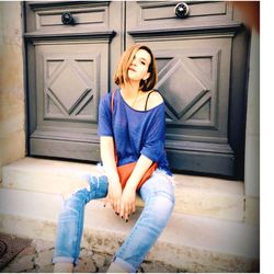 Young woman sitting against door