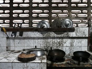 Close-up of old utensils in abandoned kitchen