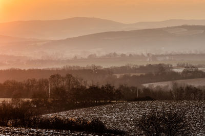 Scenic view of field against sky during foggy weather