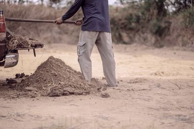 Low section of man working on field