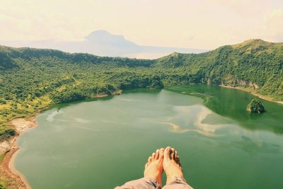 Low section of man against lake