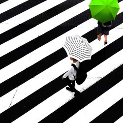 High angle view of people walking on road