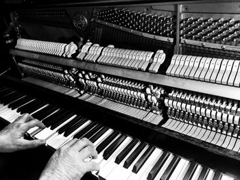 Cropped hands playing piano