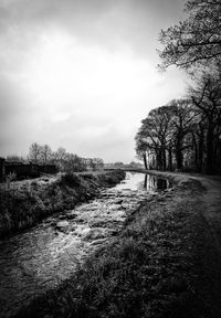 Road amidst field against sky