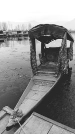 Boat moored in lake against sky