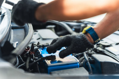 Midsection of man repairing car