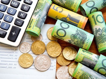 High angle view of currency and calculator on table