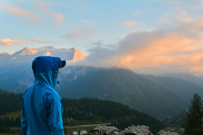 Man standing on mountain against sky