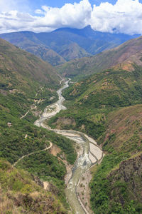 High angle view of valley amidst mountains against sky