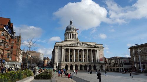 People at nottingham council house against cloudy sky