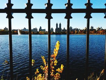 Scenic view of city by sea against sky