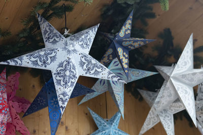 Low angle view of star shaped lanterns hanging outdoors