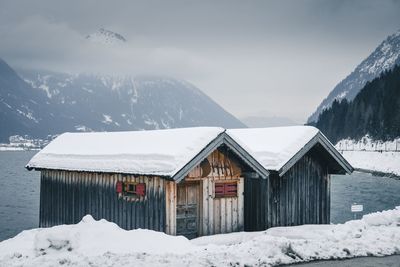 Houses on snowcapped mountains against sky