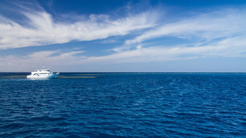 Yacht sailing on sea against sky