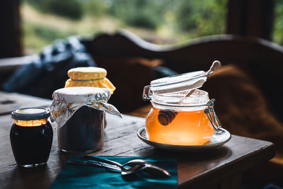 Jars of honey, jams and marmalades on the wooden table.