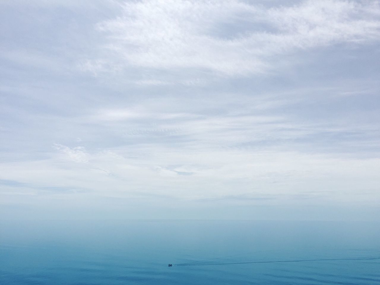 sea, tranquility, scenics, tranquil scene, water, beauty in nature, sky, blue, horizon over water, nature, cloud, day, cloud - sky, cloudscape, outdoors, calm, majestic, seascape, ocean, no people, non-urban scene, remote, solitude, atmosphere, cloudy