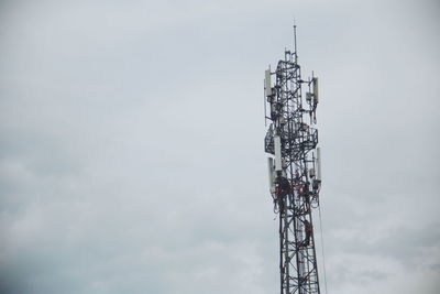 Low angle view of communications tower against sky